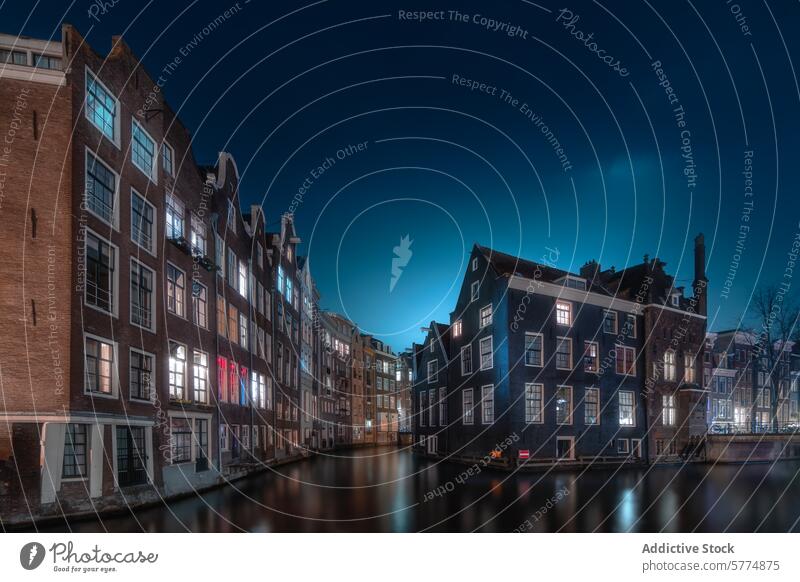 Tranquil Amsterdam Canal at Twilight amsterdam netherlands canal twilight dutch gable houses evening sky reflection water serene picturesque city dusk