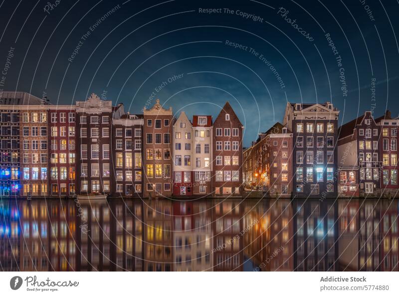 Amsterdam's Iconic Canal Houses by Night amsterdam netherlands canal house reflection water night architecture dutch historic twilight urban city building