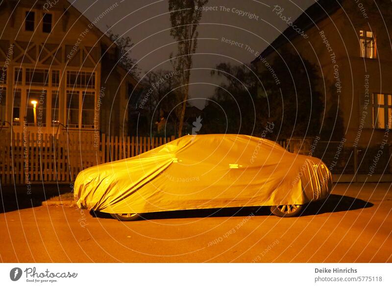 Night shot of car under hood in lantern light in front of detached houses car hood Sleeping cap evening hour evening mood Bedtime Covers (Construction) Slumber