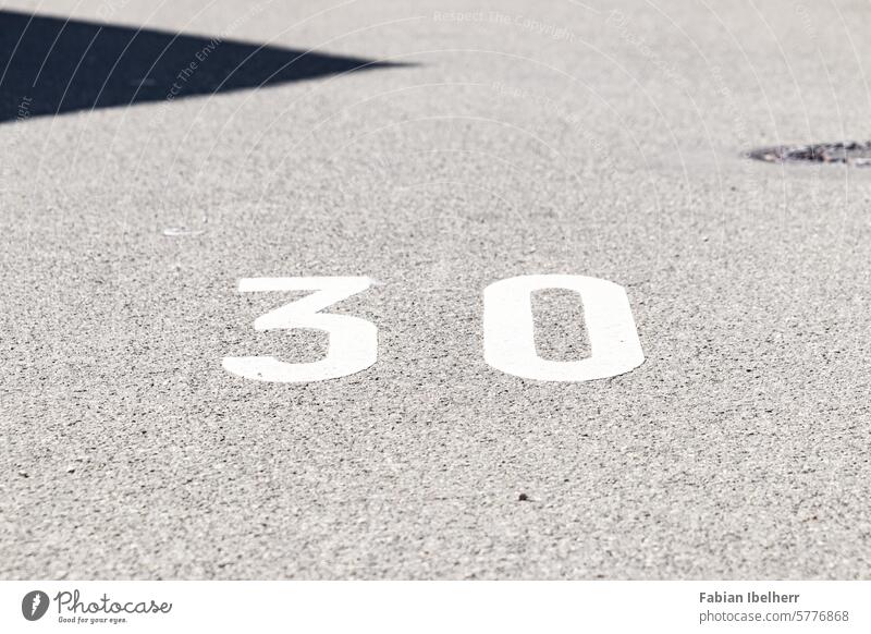 Road markings indicate a speed limit of 30 km/h Lane markings traffic-calmed tempolimit sign Road sign 30 zone Germany