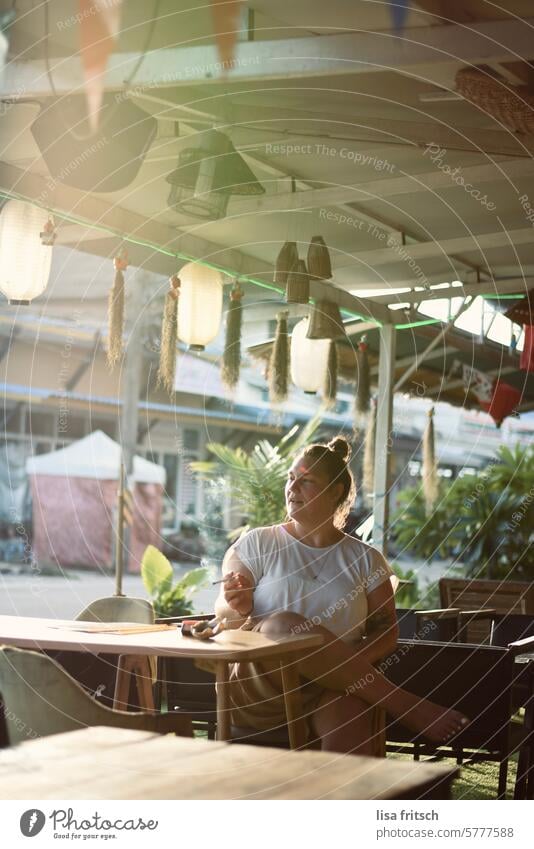 SHORT BREAK - SUMMER - THAILAND Woman 30 - 40 years Young woman Chignon Smoking Cigarette Sunlight relaxed To enjoy Exterior shot Café Sit Vacation & Travel
