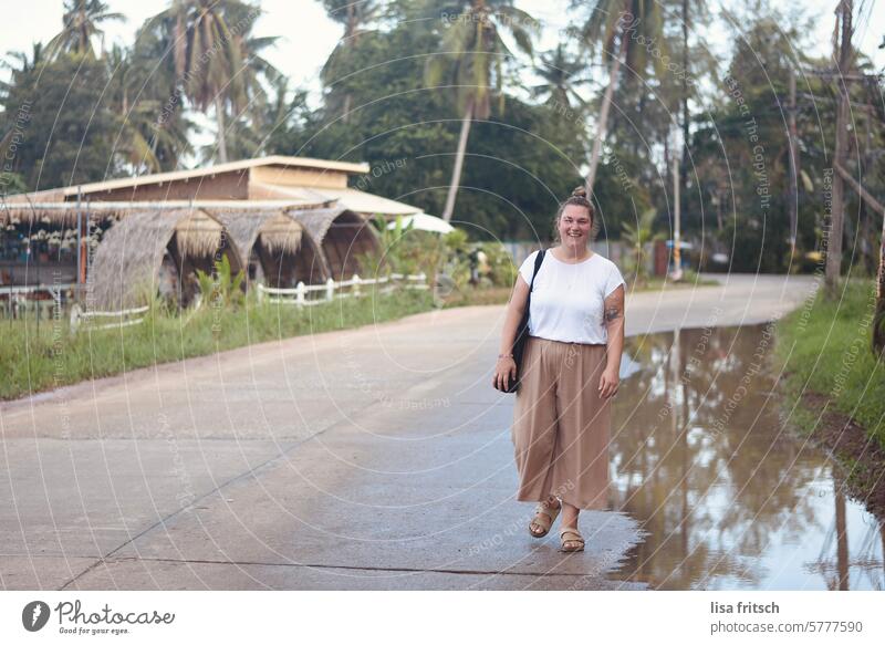 TRAVELING - IN THE MIDDLE OF NOWHERE - THAILAND Woman 30 - 40 years Blonde palms Thailand Street travel Puddle Adults Colour photo Smiling fortunate Summer