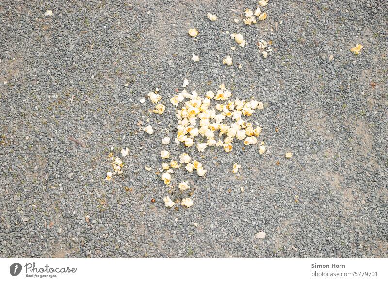 Popcorn lies on a gravel floor popcorn fell on the floor dropped Pebble Distributed Fallen clumsy by mistake furnish Spill Lose Food Food waste Waste