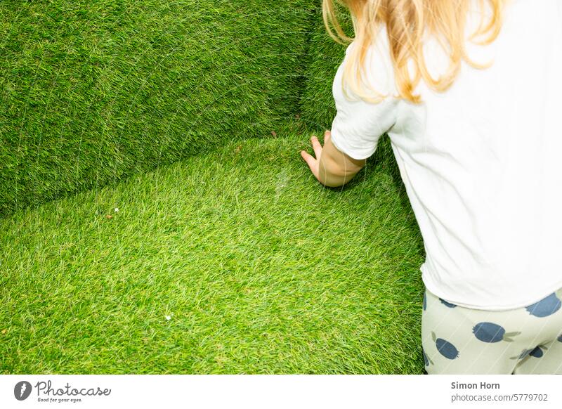 Child feels the structure of lawns that surround the child horizontally and vertically in an unusual composition Meadow fumble formed shape areas Green spaces
