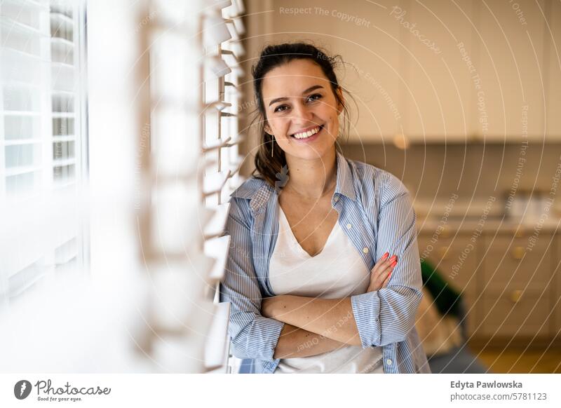 Portrait of a beautiful young woman standing in the kitchen at home people one person room living room adult young adult indoors apartment lifestyle happy