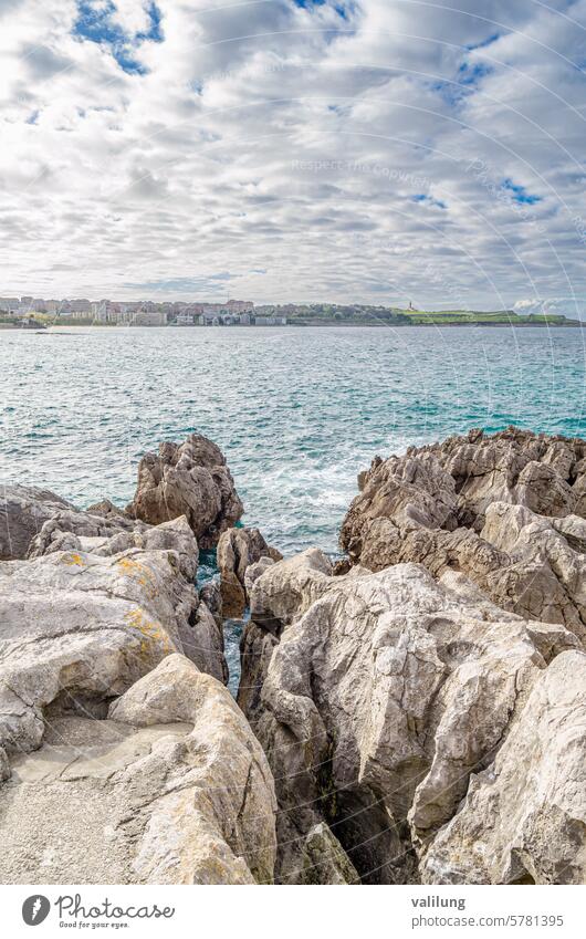 Rocky coast with the city of Santander in the background Cantabria Spain Spanish architecture atlantic attraction beach cantabric cityscape cliff coastline