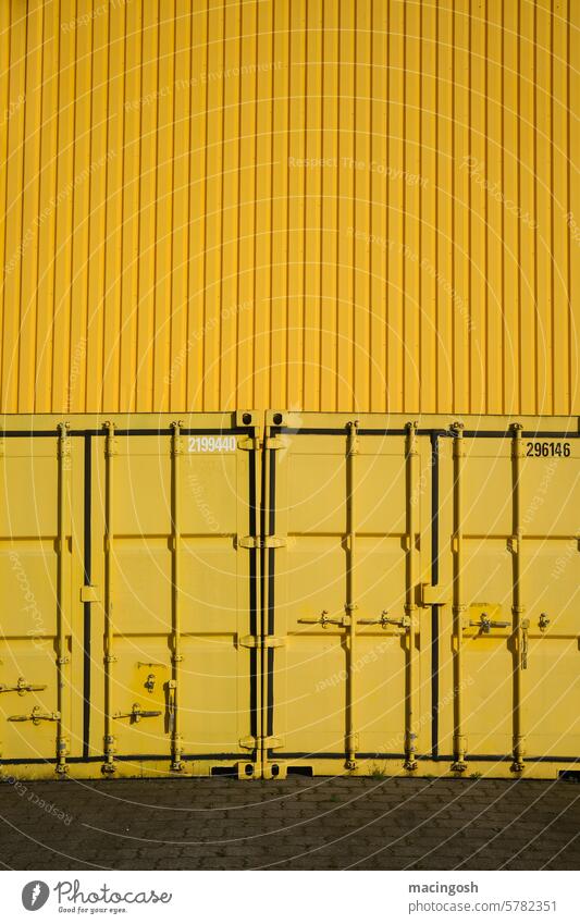 Yellow containers in front of a yellow metal wall Container Container terminal Industry Industrial hall Industrial building Industrial site Industrial area