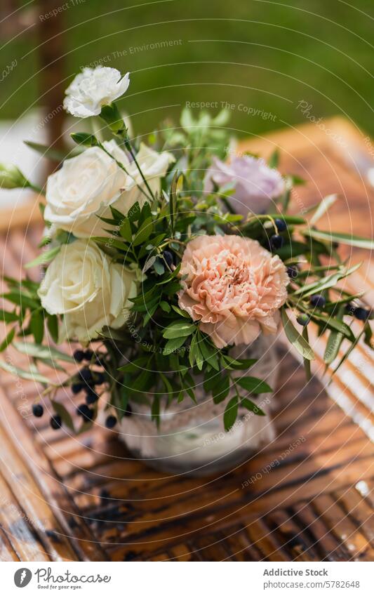 Elegant wedding centerpiece on a wooden table flower rose pink white green foliage rustic romantic bridal decoration elegant event celebration arrangement