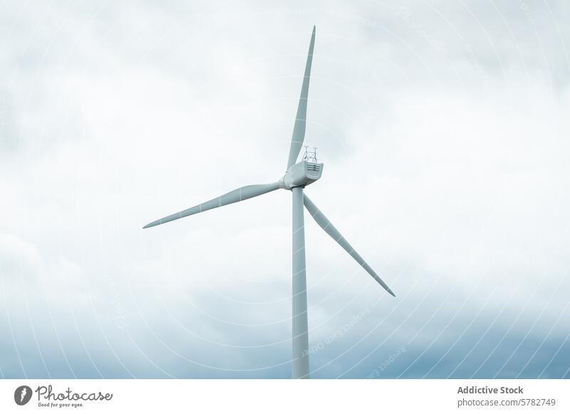 Modern wind turbine against cloudy sky renewable energy sustainable blue gray technology power electricity generation environmental eco-friendly green