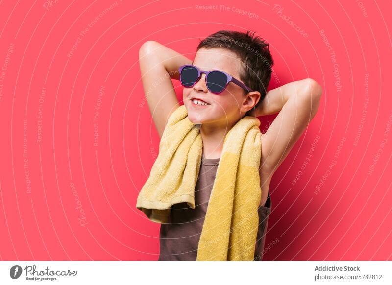 Happy boy with sunglasses enjoying summer vibes child happy smile cheerful pink background yellow towel leisure fun casual bright vibrant fashion accessory