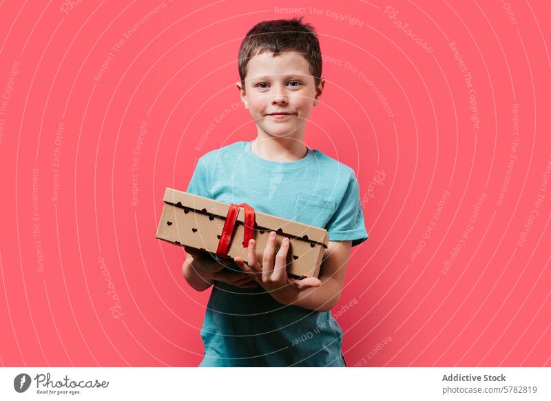 Boy with a cardboard airplane on a pink background boy handmade smile young child proud hold small craft red detail playful joy happiness model diy creative