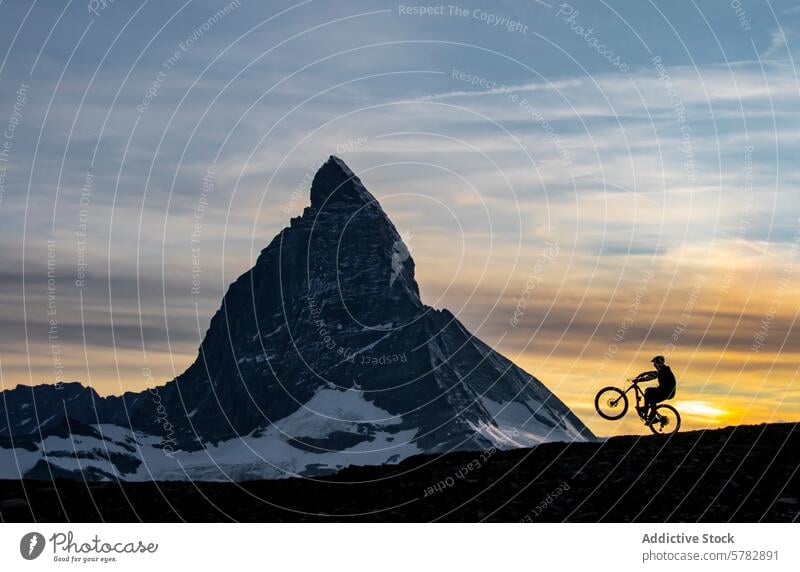 Summer biking silhouette against mountain at sunset summer cyclist evening ride majestic backdrop sky adventure outdoor nature dusk tranquility leisure activity