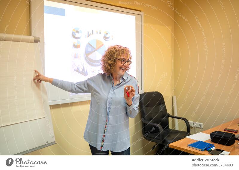 Senior woman leading a business seminar senior teacher education projector classroom presentation chart learning glasses smile professional adult teaching