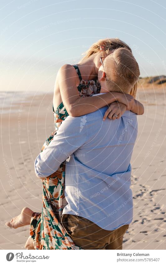 man and woman kissing on the beach cuddle love engagement romantic couple Together hug together affection romance fondness embrace happy relationship