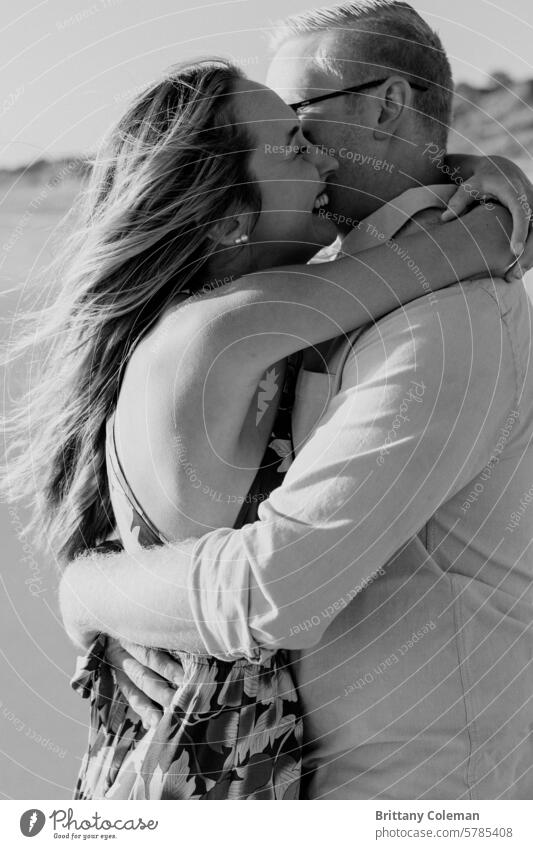 black and white image of man and woman hugging cuddle love engagement romantic couple Together together affection romance fondness embrace happy