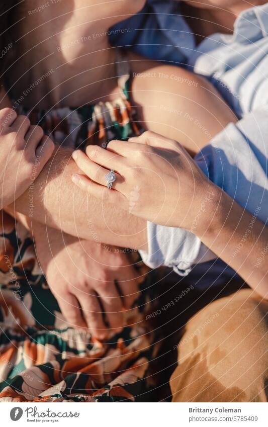 close up of man and woman cuddling engagement ring cuddle hands love romantic couple Together