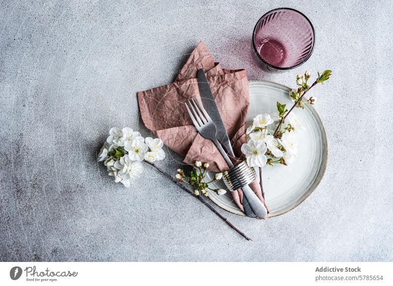 Elegant spring table setting with cherry blossoms elegant vintage plate silverware napkin dusty rose flower delicate event theme decoration floral design