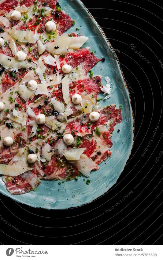 Gourmet beef carpaccio with parmesan and pearl garnish gourmet parmesan cheese edible pearl herb ceramic plate appetizer shaved cheese elegant sprinkles