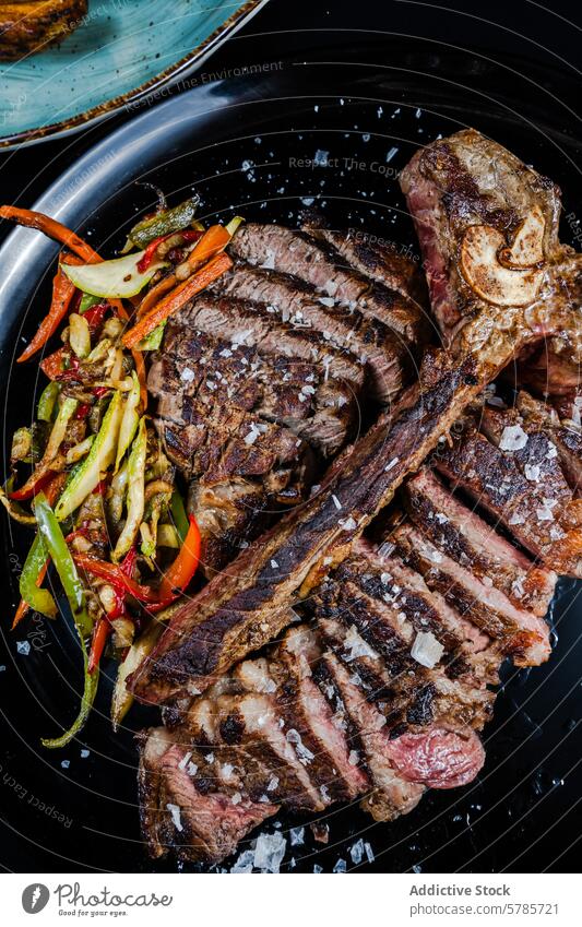 Perfectly cooked T-bone steak with sauteed vegetables beef t-bone aged 21-days perfection salt flakes garnished plated meat main course dinner grilled savory