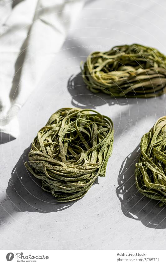 Fresh Green Pasta Nests on a White Background pasta green nest raw italian cuisine food homemade gourmet healthy spinach meal ingredient culinary preparation