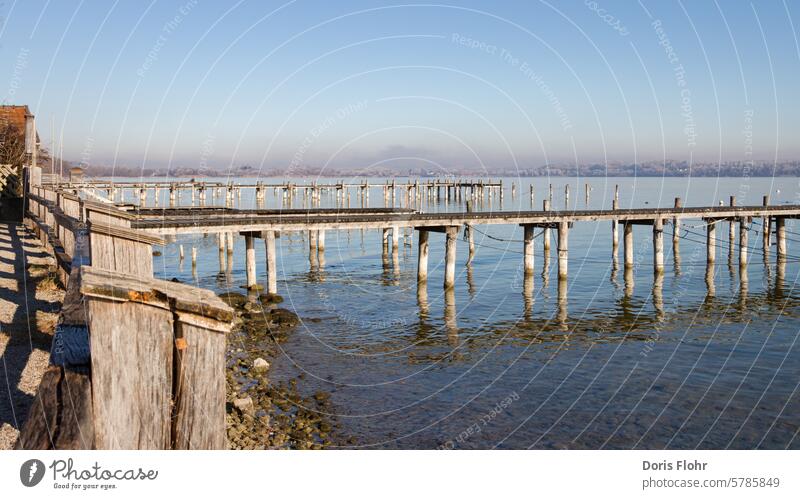 Jetties on the Ammersee jetty Lake Ammer Schondorf Sailing Winter morning mood clear air Water Sky Relaxation Lakeside Footbridge Beautiful weather Nature