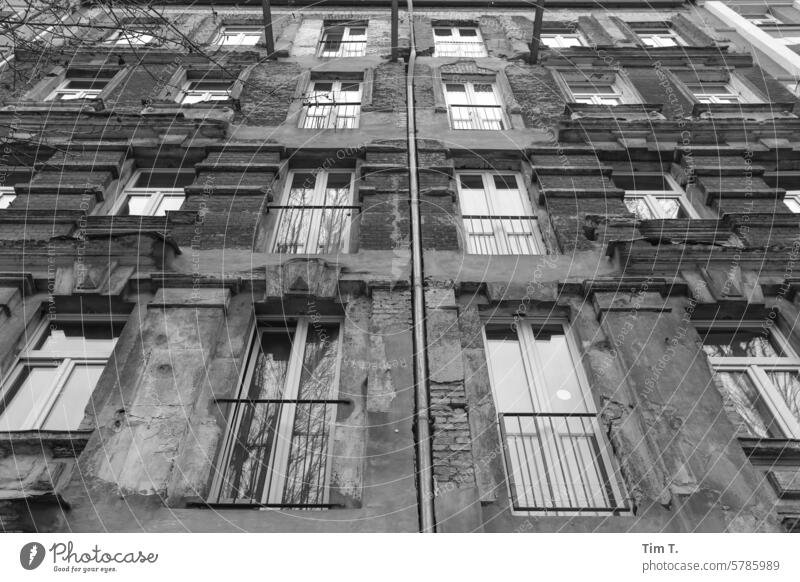 Old building façade with lost balconies Facade b/w Prenzlauer Berg Berlin Window Old town Black & white photo Capital city Town Downtown Day Deserted Building