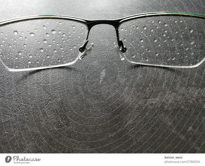 The glasses are wet after the tour through the rain Eyeglasses Wet raindrops Spectacle lenses Drops of water Glasses Close-up Water Rain Rainy weather Weather