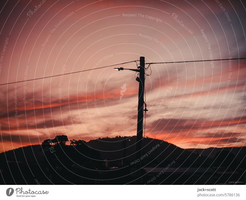 illuminated between day and night Evening Clouds in the sky evening mood Twilight Sky Sunset Electricity pylon Light (Natural Phenomenon) Silhouette
