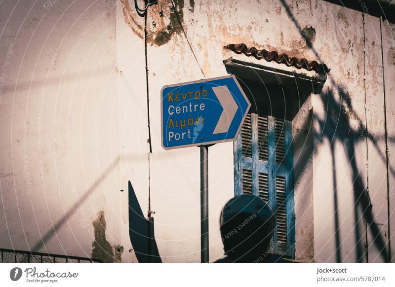 Mobility in Greece Motorbike helmet Road sign Road marking Greek English Direction Signage Facade Weathered Sunlight Shadow Shutter Old Silhouette