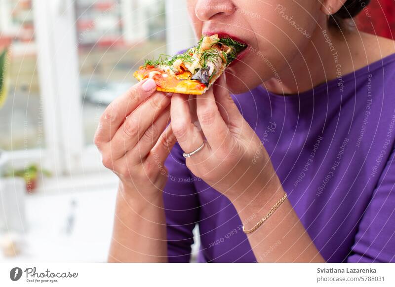 Woman's hands hold a piece of pizza in her hand. Eating pizza hungry eat food dinner slice delicious snack meal lunch casual tasty italian lifestyle cheese one