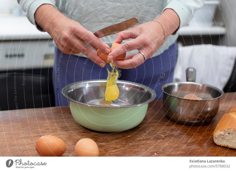 Cook breakfast. Hands break eggs to prepare an omelet. cook food kitchen woman female chef hands home making bowl healthy close up meal culinary ingredient