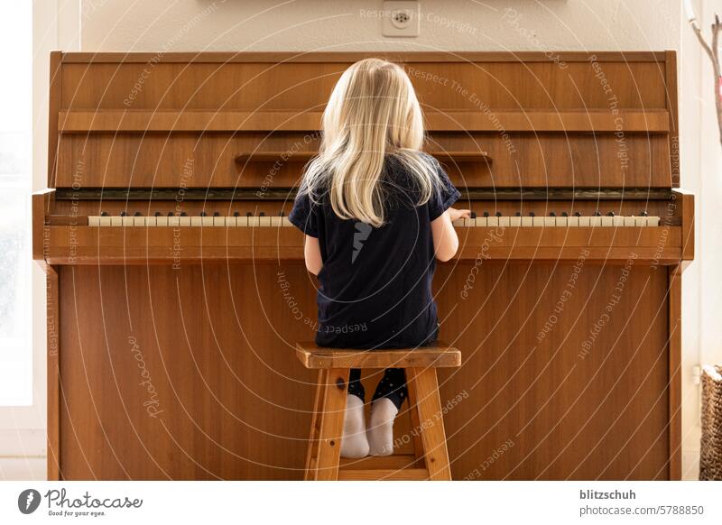 Girl at the piano Piano Play piano Music Musical instrument Make music Practice Keyboard instrument Leisure and hobbies Musician fumble Piano lessons Art Sound