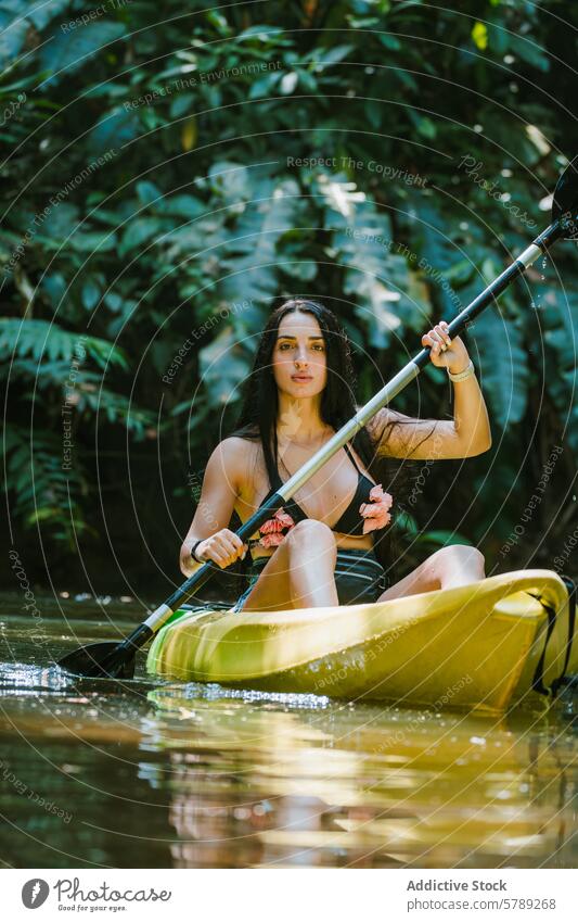 Woman Enjoying Kayak Adventure in Costa Rican Jungle woman kayak adventure costa rica jungle greenery water paddle lush relaxation tranquility nature travel