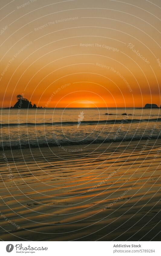 Serene sunset at a Costa Rican beach costa rica sand waves golden hour serene sky islet silhouette travel nature landscape ocean tranquility evening dusk shore