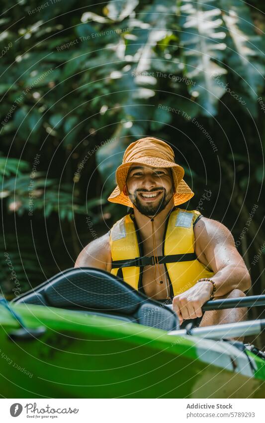 Kayaking adventurer enjoys the wilds of Costa Rica kayaking man smile happy nature costa rica jungle greenery life vest tropical leisure activity sport paddle