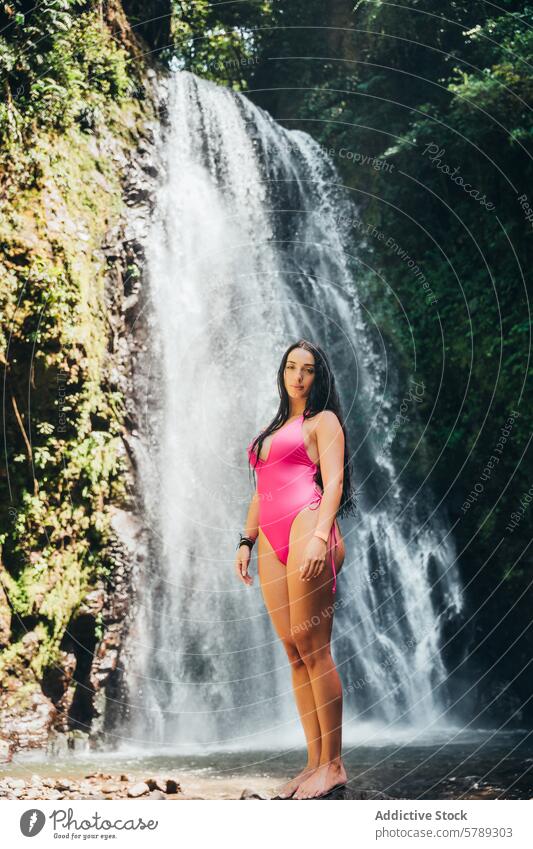 Woman in Pink Swimsuit by Costa Rican Waterfall woman pink swimsuit waterfall costa rica tropical adventure nature travel vacation leisure outdoors scenery