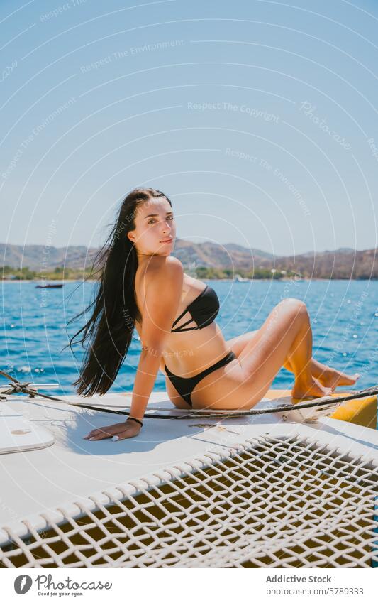 Young woman relaxing on a yacht in Costa Rica costa rica sea bikini sunbathing travel vacation leisure luxury nautical marine coastline tropical summer ocean