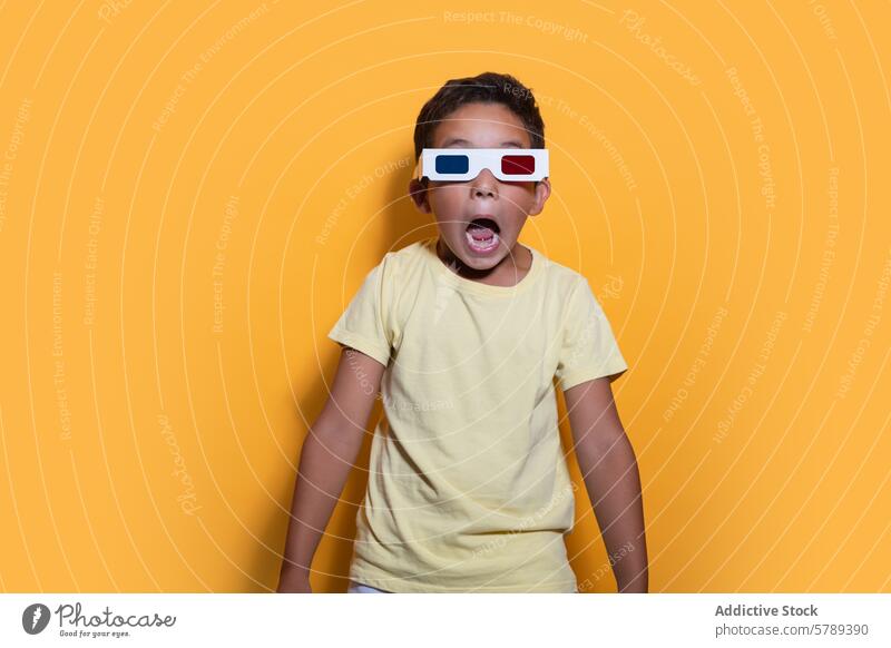 Excited child with 3D glasses on a yellow background studio amazement 3d glasses bright backdrop casual clothing expression excitement fun entertainment