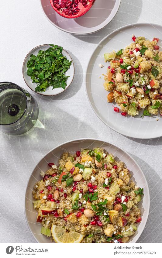 Healthy quinoa salad with pomegranate and nuts, top view herbs bowl healthy colorful garnished seeds almonds parsley lemon vegetarian vegan dish meal cuisine