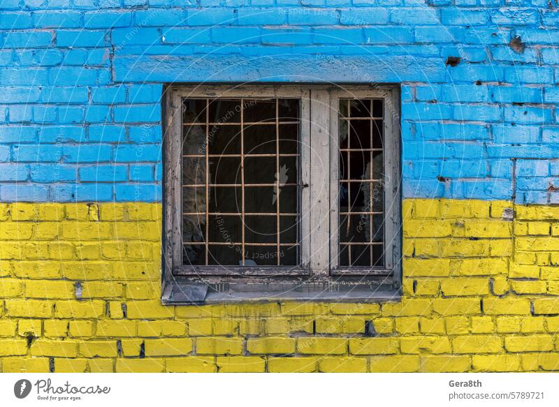 pattern explosion damaged blue yellow house wall with window in Ukraine Donetsk Kherson Kyiv Lugansk Mariupol Russia Zaporozhye abandon abandoned attack