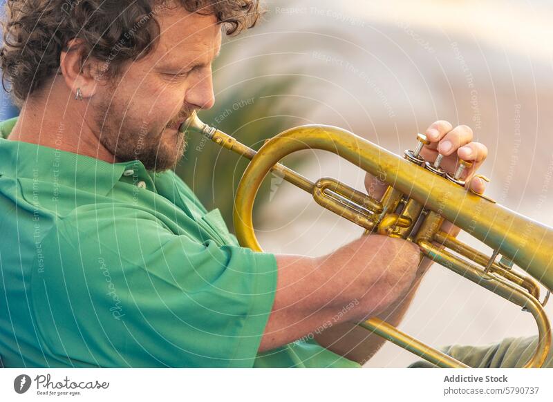 Passionate one-armed trumpet player performs outdoors man street music performing passion performance musician instrument brass dedication perseverance disabled