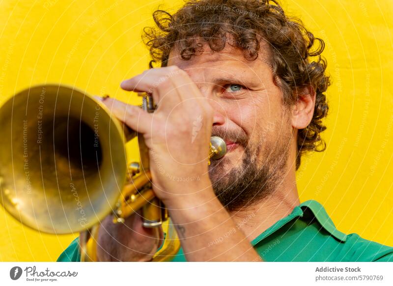 Inspirational one-armed trumpeter playing passionately resilience music street performance musician inspirational determined brass instrument yellow backdrop