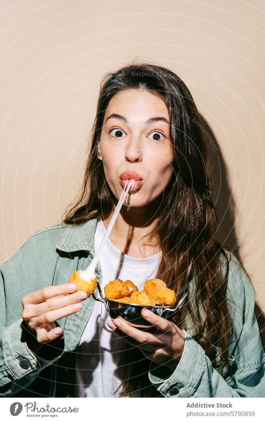 Woman enjoying crunchy potato dips with ketchup woman snacking enjoyment playful young fun straw sipping holding golden-brown dish food casual pleasure happy