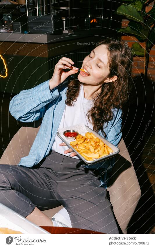 Casual dining experience with delicious French fries woman french fries ketchup casual meal tray golden enjoyment eating sitting restaurant fast food snack