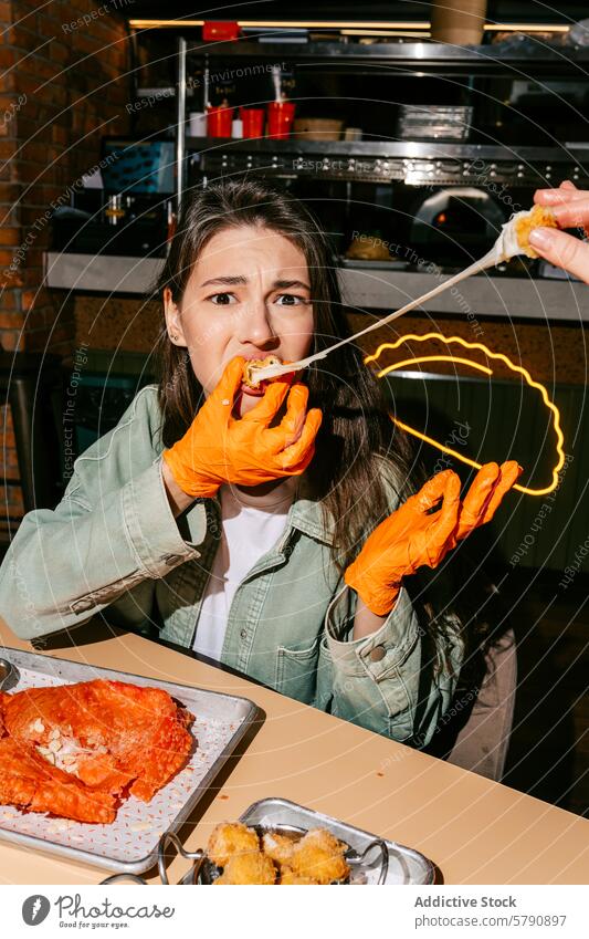 Woman enjoying a gooey cheburek in a casual dining setting woman eating cheese bite fried mozzarella orange gloves baked fresh oozing laid-back eatery young