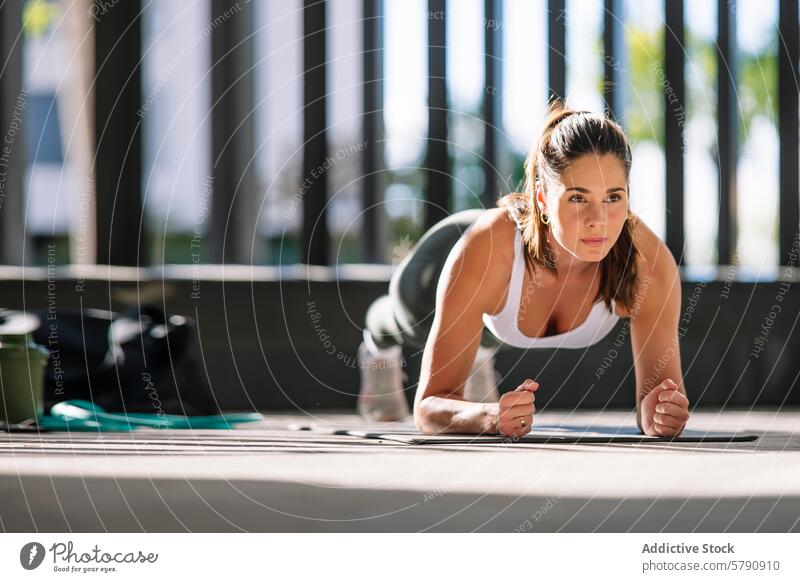 Determined Woman Exercising at Home woman athlete fitness exercise plank home indoor determination sportswear workout healthy lifestyle strength training floor