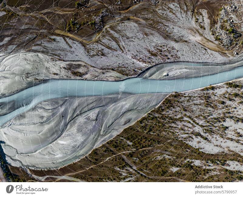 High-resolution aerial snapshot showcasing a sinuous mountain river carving through a textured landscape with varied terrain winding high-resolution earth