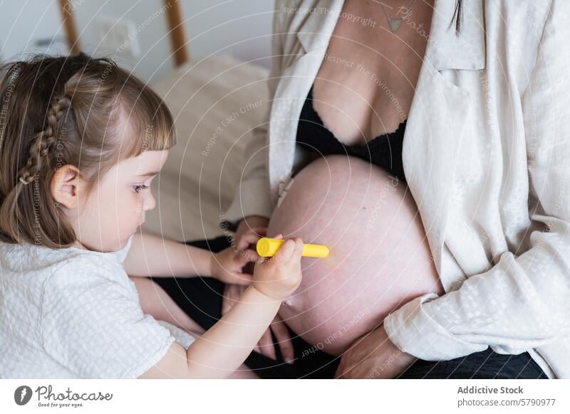 Young child interacts with pregnant mothers belly touch curiosity woman family maternity care love toddler pregnancy expectant daughter interaction affection