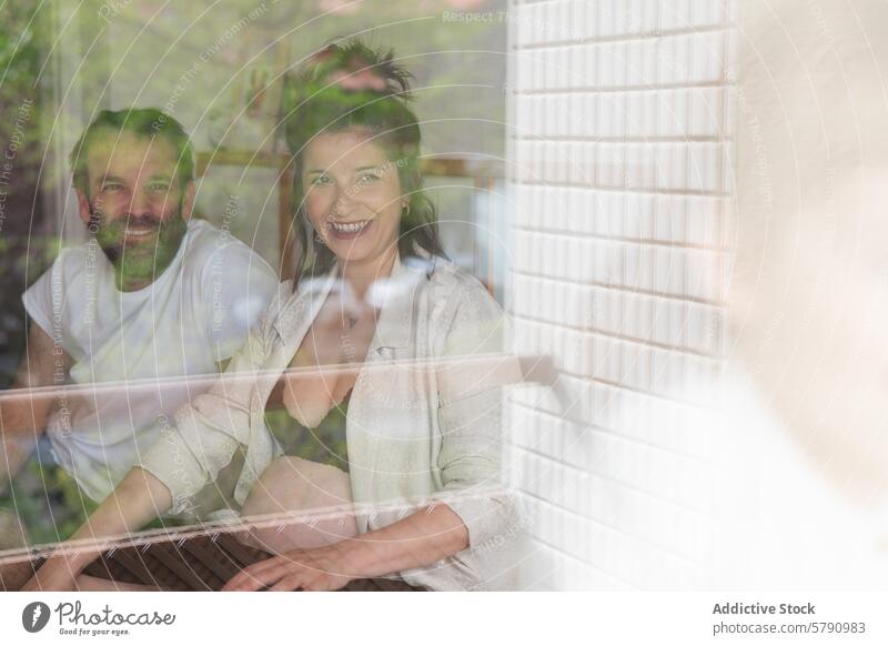 Couple enjoying a cozy moment at home couple window laugh comfortable setting happy sharing indoor domestic life leisure smile man woman casual clothing