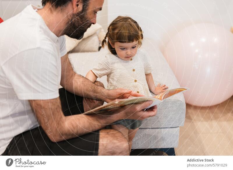 Tender moment of father-daughter reading time storybook attention learning family home bonding care parent child education literacy attentive quality time